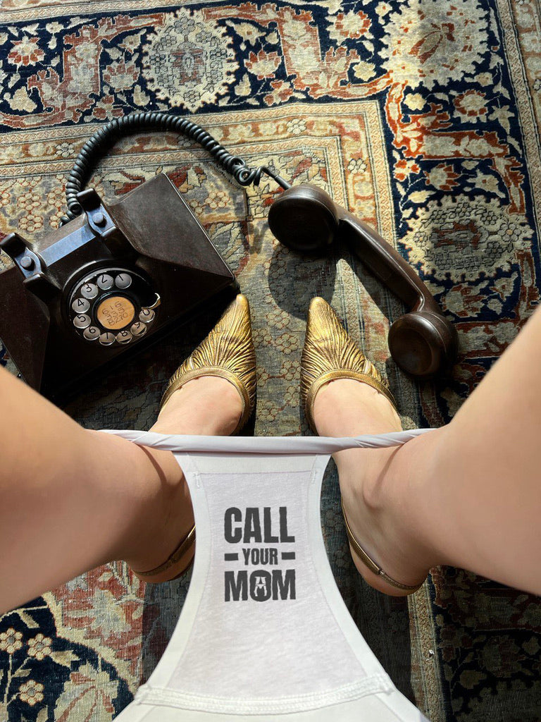Underwear for women with a secret message call your mom near a phone on a rug