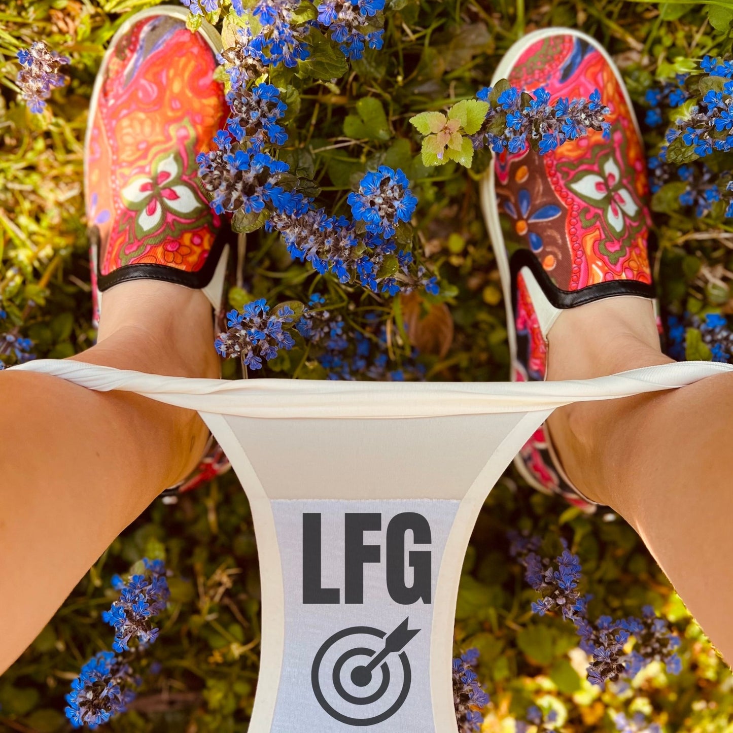 Womens underwear with 'LFG' branding, surrounded by grass and flowers.